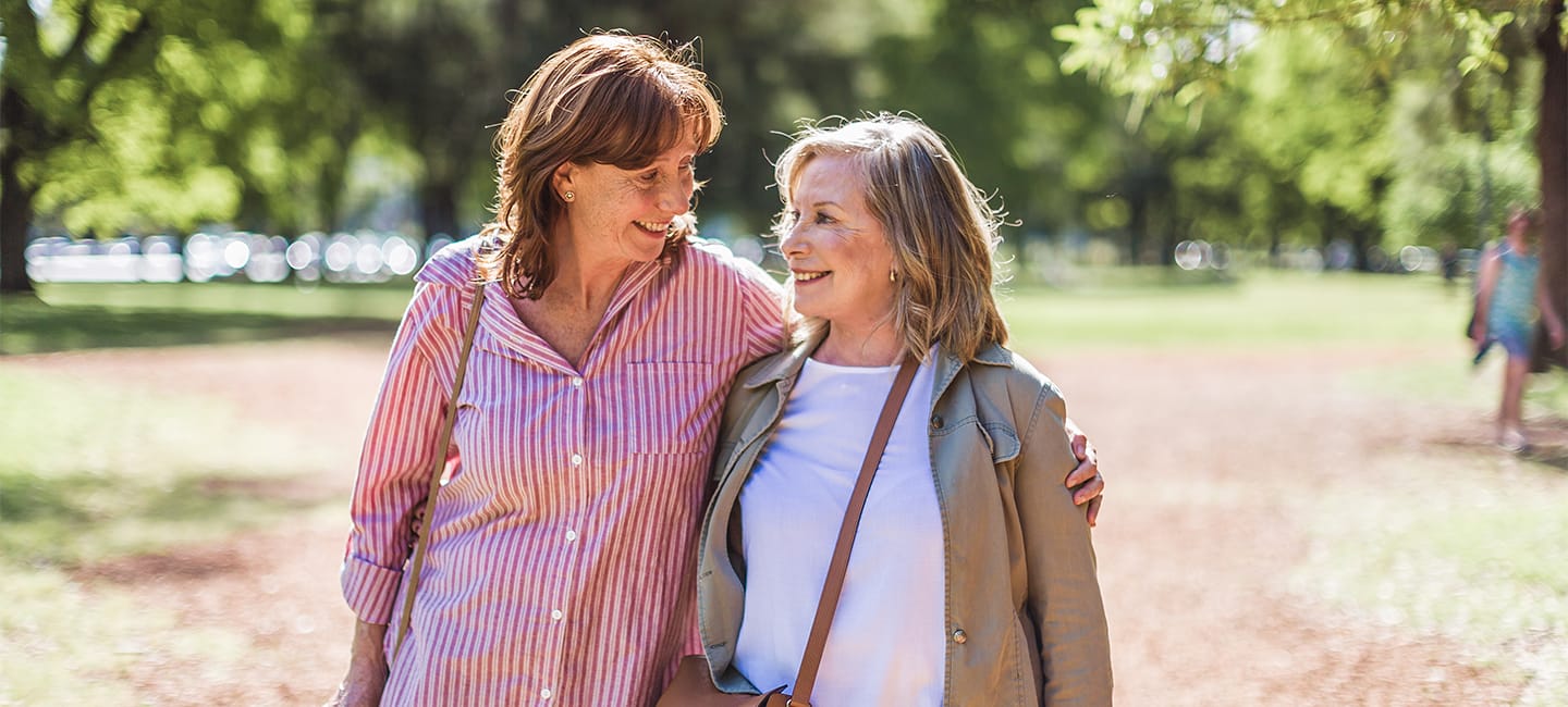 Senior female couple walking and talking through the park. Buenos Aires, Argentina